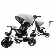 Baby tricycle and stroller combo with gray canopy on a white background