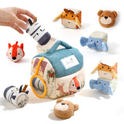 Set of soft animal toys with a cube-shaped toy featuring a house design on a white background.
