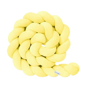 Yellow knitted rope toy on a white background