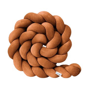 Brown braided pillow on a white background