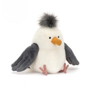 Plush toy penguin with gray wings and a white body on a white background