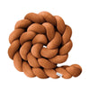Brown braided pillow on a white background