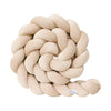 Beige braided pillow on a white background