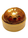 Gold glittery ball with a face design in a beige container on a white background