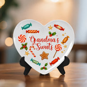 Heart-shaped decorative plaque with candy-themed design and 'Grandma's Sweets' text on a stand.