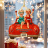 Decorative ornament with two women in a car, holding drinks, with personalized names and year.