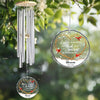 Decorative wind chime with personalized hanging ornament against a natural background