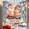 Decorative Christmas ornament of a couple in Santa hats with names 'David' and 'Helen', and text 'Growing old together since 1998'.