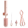 Set of pink cleaning tools including a brush, scissors, and other utensils on a white background.