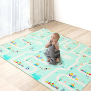 Baby playing on a colorful play mat with toy cars and animals in a room.